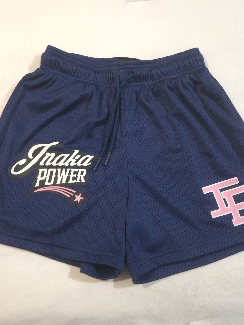 Inaka Power Navy Mesh Athletic Shorts with Pink Accents.